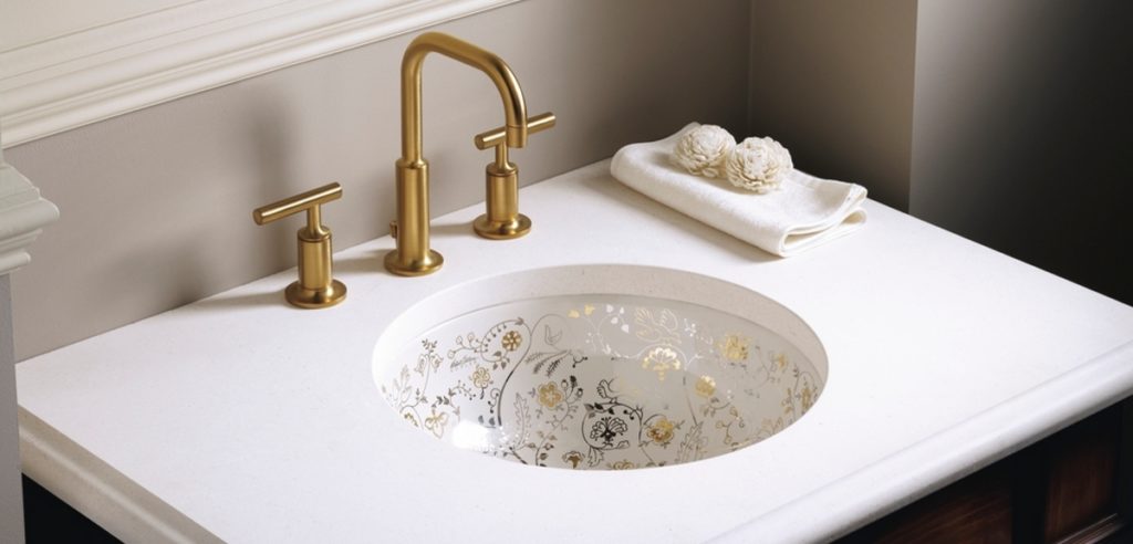 bathroom sink with brushed gold faucet